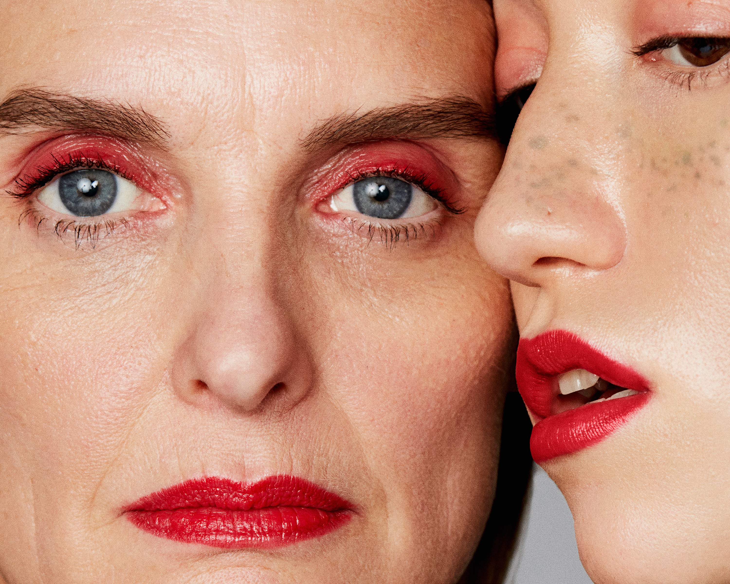 Two woman, red eye makeup, bold red lips, makeup