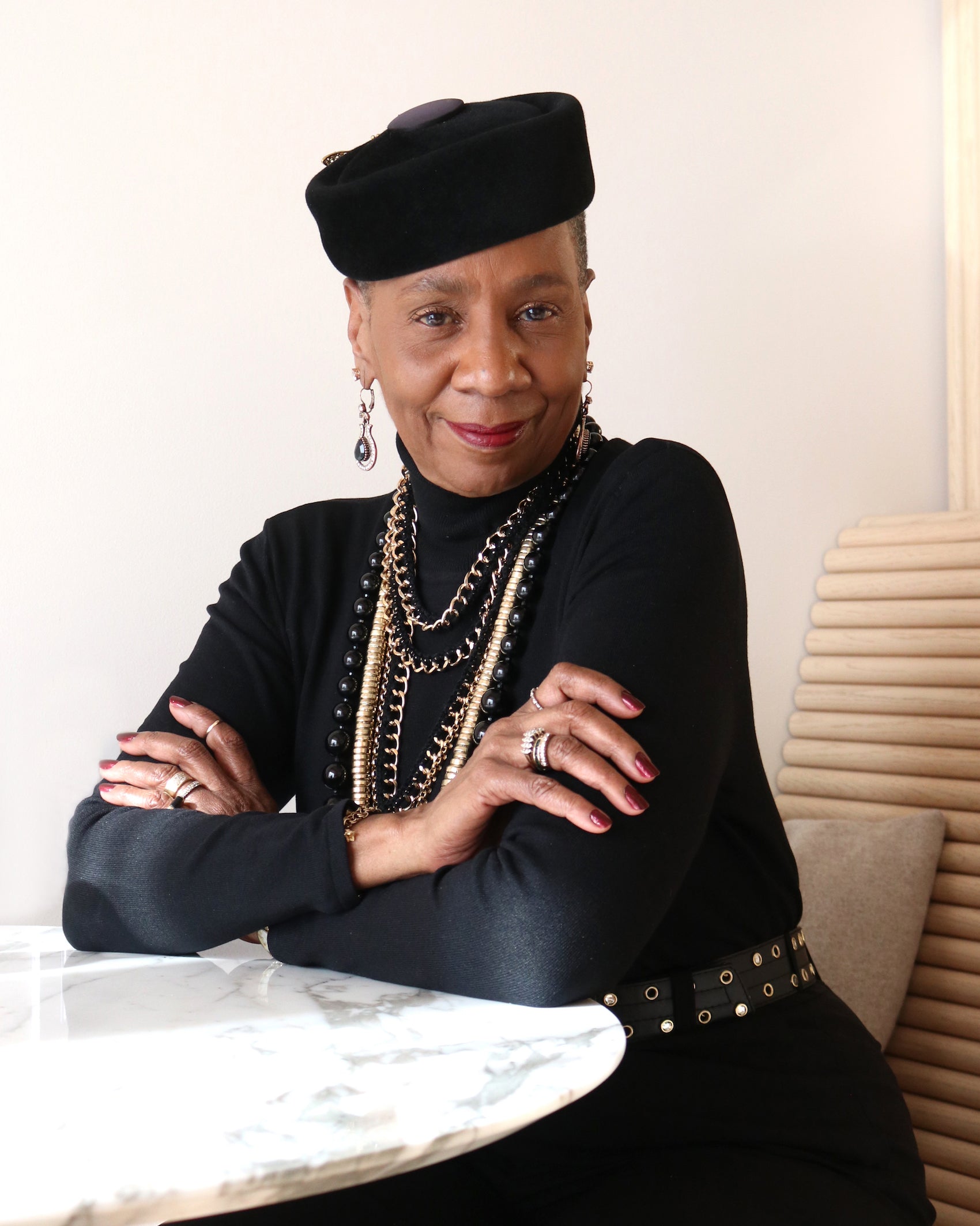 Smiling woman with red lipstick and black hat