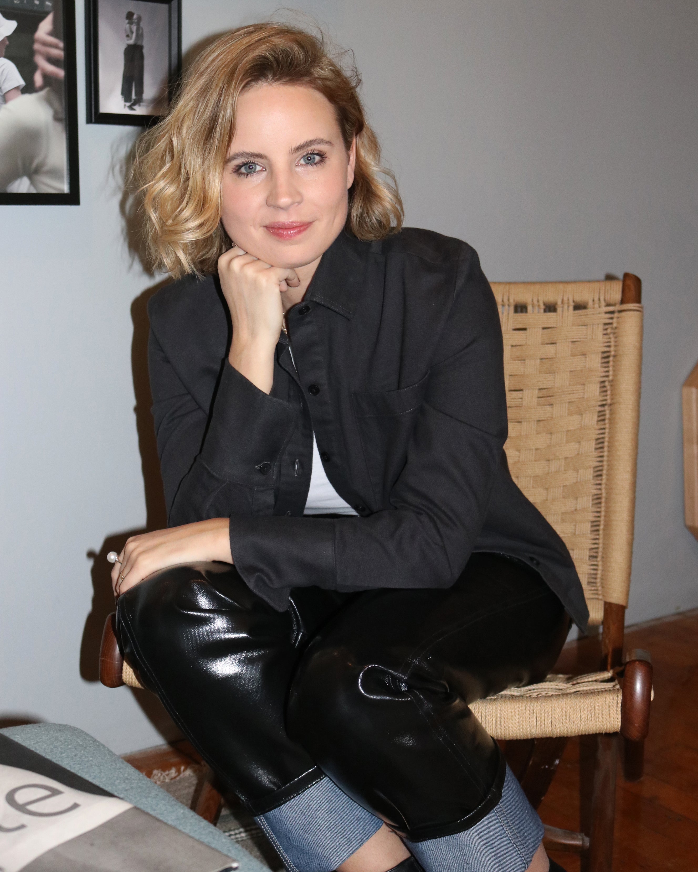 Woman sitting, smiling, red lipstick, makeup